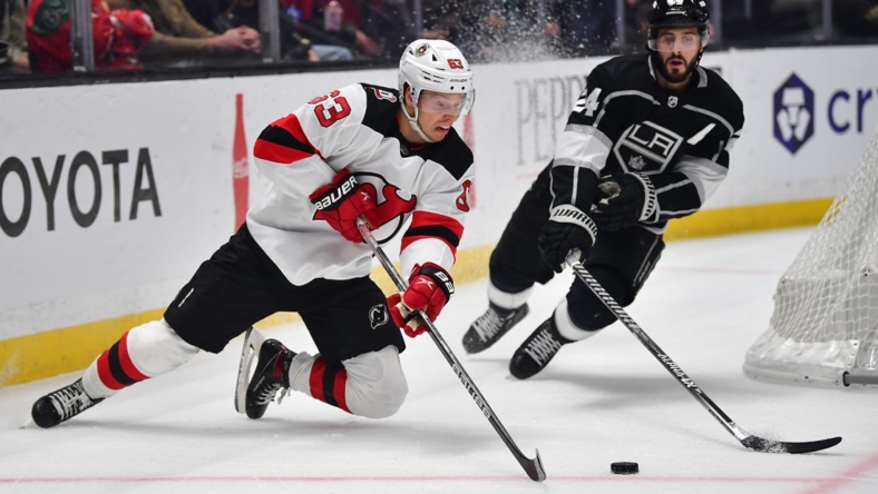 January 14, 2023; Los Angeles, California, USA; New Jersey Devils left wing Jesper Bratt (63) moves the puck against Los Angeles Kings center Phillip Danault (24) during the first period at Crypto.com Arena. Mandatory Credit: Gary A. Vasquez-USA TODAY Sports