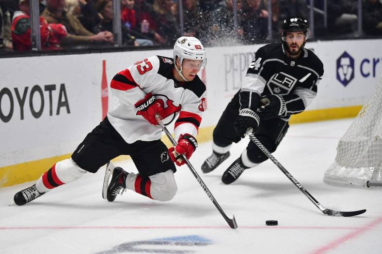 January 14, 2023; Los Angeles, California, USA; New Jersey Devils left wing Jesper Bratt (63) moves the puck against Los Angeles Kings center Phillip Danault (24) during the first period at Crypto.com Arena. Mandatory Credit: Gary A. Vasquez-USA TODAY Sports