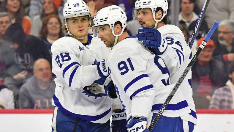 Jan 8, 2023; Philadelphia, Pennsylvania, USA; Toronto Maple Leafs right wing William Nylander (88), center John Tavares (91), and center Auston Matthews (34) celebrate a goal against the Philadelphia Flyers at Wells Fargo Center. Mandatory Credit: Eric Hartline-USA TODAY Sports