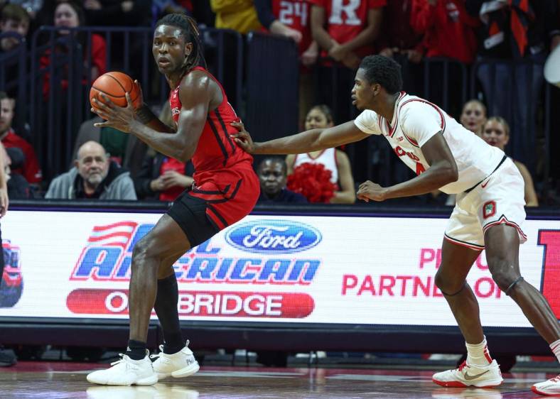 Jan 15, 2023; Piscataway, New Jersey, USA; Rutgers Scarlet Knights center Clifford Omoruyi (11) dribbles against Ohio State Buckeyes center Felix Okpara (34) during the first half at Jersey Mike's Arena. Mandatory Credit: Vincent Carchietta-USA TODAY Sports
