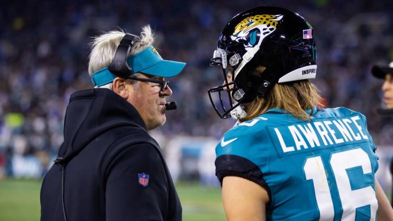 Jan 14, 2023; Jacksonville, Florida, USA; Jacksonville Jaguars quarterback Trevor Lawrence (16) talks with head coach Doug Pederson in the first half against the Los Angeles Chargers during a wild card game at TIAA Bank Field. Mandatory Credit: Mark J. Rebilas-USA TODAY Sports