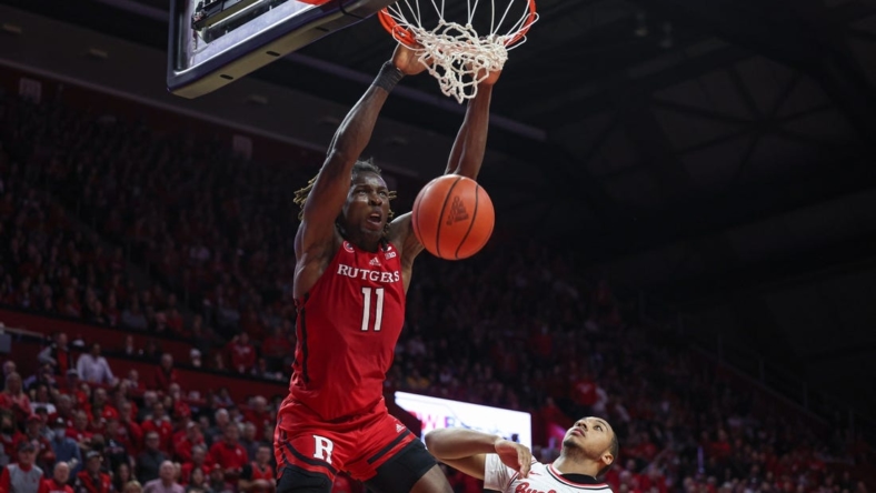 Jan 15, 2023; Piscataway, New Jersey, USA;  Rutgers Scarlet Knights center Clifford Omoruyi (11) dunks over Ohio State Buckeyes forward Zed Key (23) in overtime at Jersey Mike's Arena. Mandatory Credit: Vincent Carchietta-USA TODAY Sports