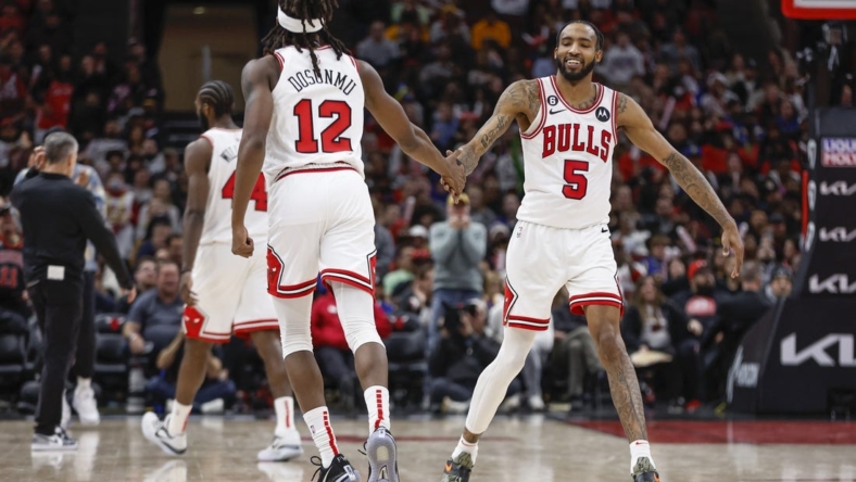 Jan 15, 2023; Chicago, Illinois, USA; Chicago Bulls guard Ayo Dosunmu (12) is congratulated by forward Derrick Jones Jr. (5) after scoring against the Golden State Warriors during the second half of an NBA game at United Center. Mandatory Credit: Kamil Krzaczynski-USA TODAY Sports