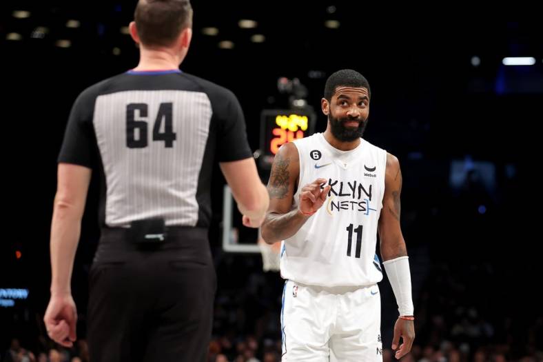Jan 15, 2023; Brooklyn, New York, USA; Brooklyn Nets guard Kyrie Irving (11) gestures at referee Justin Van Duyne (64) during the third quarter against the Oklahoma City Thunder at Barclays Center. Mandatory Credit: Brad Penner-USA TODAY Sports