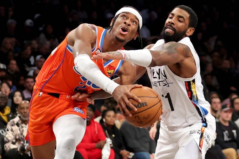 Jan 15, 2023; Brooklyn, New York, USA; Oklahoma City Thunder guard Shai Gilgeous-Alexander (2) is fouled as he drives to the basket by Brooklyn Nets guard Kyrie Irving (11) during the third quarter at Barclays Center. Mandatory Credit: Brad Penner-USA TODAY Sports