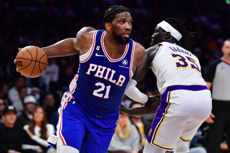 Jan 15, 2023; Los Angeles, California, USA; Philadelphia 76ers center Joel Embiid (21) moves the ball against Los Angeles Lakers forward Wenyen Gabriel (35) during the first half at Crypto.com Arena. Mandatory Credit: Gary A. Vasquez-USA TODAY Sports