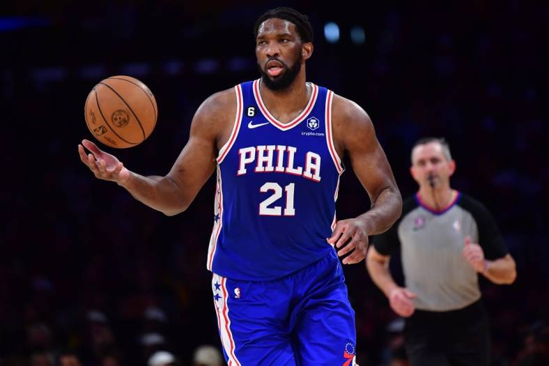 Jan 15, 2023; Los Angeles, California, USA; Philadelphia 76ers center Joel Embiid (21) brings the ball up court against the Los Angeles Lakers during the first half at Crypto.com Arena. Mandatory Credit: Gary A. Vasquez-USA TODAY Sports