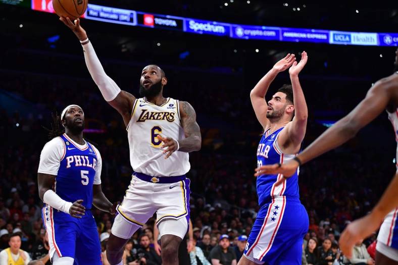 Jan 15, 2023; Los Angeles, California, USA; Los Angeles Lakers forward LeBron James (6) moves to the basket ahead of Philadelphia 76ers forward Georges Niang (20) during the second half at Crypto.com Arena. Mandatory Credit: Gary A. Vasquez-USA TODAY Sports