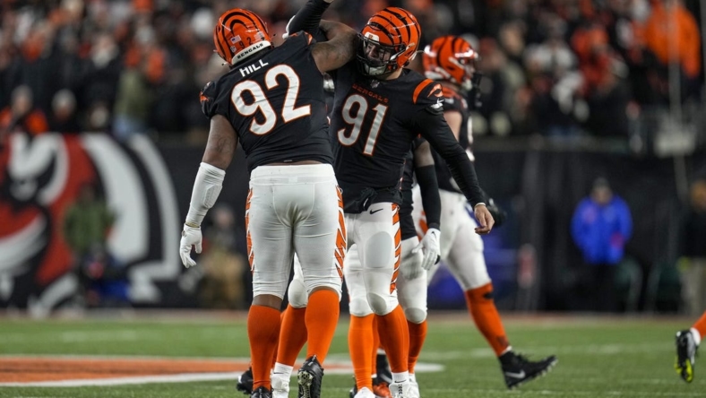 Jan 15, 2023; Cincinnati, Ohio, USA; Cincinnati Bengals defensive tackle BJ Hill (92) and defensive end Trey Hendrickson (91) celebrate a stop in the fourth quarter during an NFL wild-card playoff football game between the Baltimore Ravens and the Cincinnati Bengals at Paycor Stadium. Mandatory Credit: Sam Greene-USA TODAY Sports