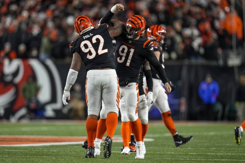 Jan 15, 2023; Cincinnati, Ohio, USA; Cincinnati Bengals defensive tackle BJ Hill (92) and defensive end Trey Hendrickson (91) celebrate a stop in the fourth quarter during an NFL wild-card playoff football game between the Baltimore Ravens and the Cincinnati Bengals at Paycor Stadium. Mandatory Credit: Sam Greene-USA TODAY Sports