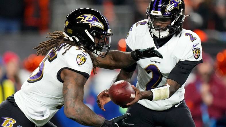 Jan 15, 2023; Cincinnati, Ohio, USA; Baltimore Ravens quarterback Tyler Huntley (2) hands the ball off to Baltimore Ravens running back Gus Edwards (35) in the fourth quarter during an NFL wild-card playoff football game between the Baltimore Ravens and the Cincinnati Bengals during a wild card game at Paycor Stadium. Mandatory Credit: Kareem Elgazzar-USA TODAY Sports