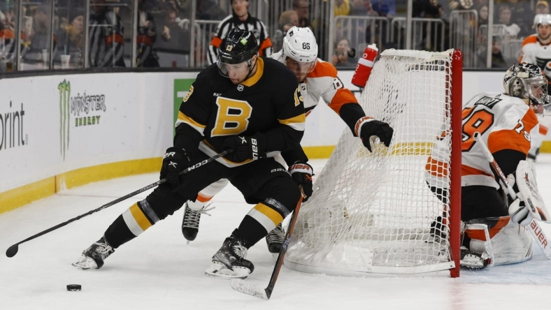Jan 16, 2023; Boston, Massachusetts, USA; Boston Bruins center Charlie Coyle (13) cuts off Philadelphia Flyers left wing Joel Farabee (86) as he goes around the net during the first period at TD Garden. Mandatory Credit: Winslow Townson-USA TODAY Sports