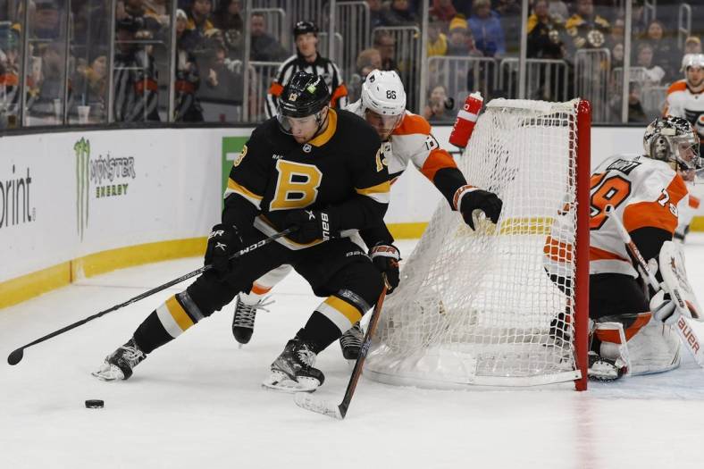 Jan 16, 2023; Boston, Massachusetts, USA; Boston Bruins center Charlie Coyle (13) cuts off Philadelphia Flyers left wing Joel Farabee (86) as he goes around the net during the first period at TD Garden. Mandatory Credit: Winslow Townson-USA TODAY Sports