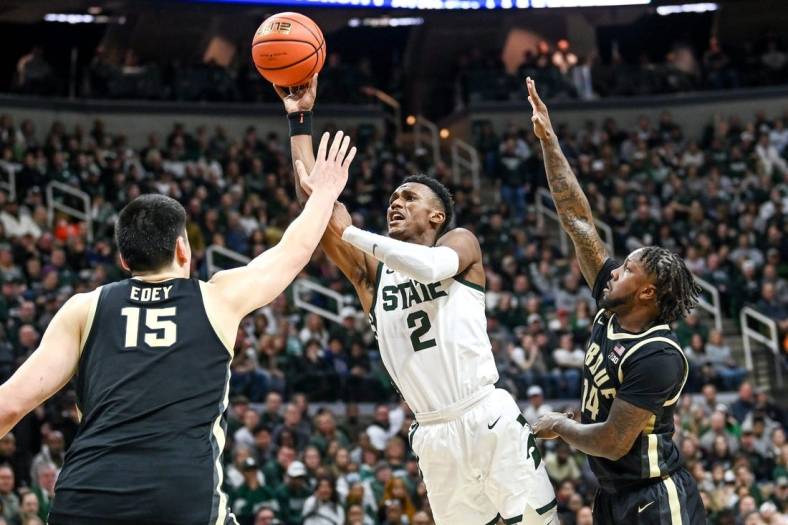 Michigan State's Tyson Walker, center, shoots between Purdue's Zach Edey, left, and David Jenkins Jr. during the first half on Monday, Jan. 16, 2023, at the Breslin Center in East Lansing.

230116 Msu Purdue Bball 081a