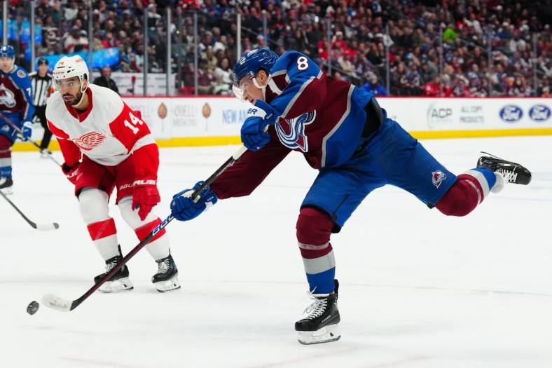 Jan 16, 2023; Denver, Colorado, USA; Colorado Avalanche defenseman Cale Makar (8) shoots the puck past Detroit Red Wings center Robby Fabbri (14) in the second period at Ball Arena. Mandatory Credit: Ron Chenoy-USA TODAY Sports