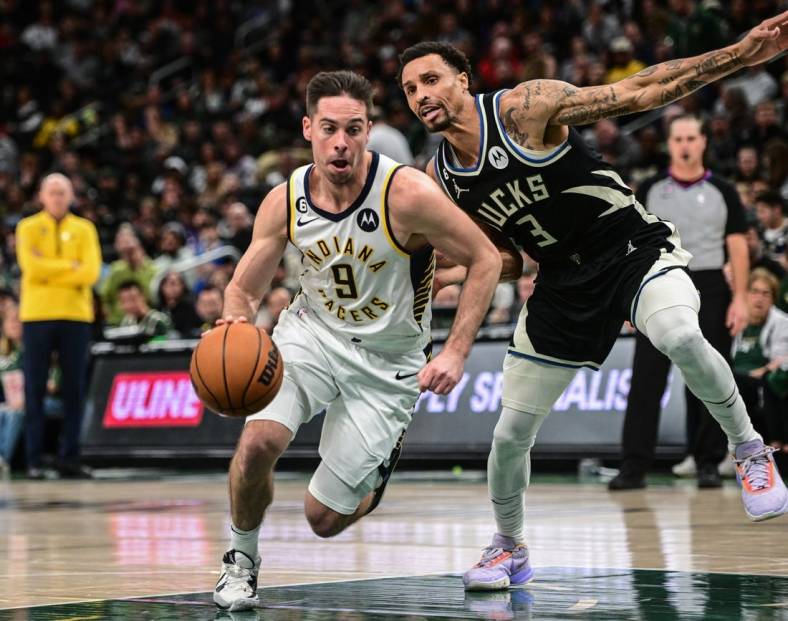 Jan 16, 2023; Milwaukee, Wisconsin, USA; Indiana Pacers guard T.J. McConnell (9) drives for the basket against Milwaukee Bucks guard George Hill (3) in the third quarter at Fiserv Forum. Mandatory Credit: Benny Sieu-USA TODAY Sports