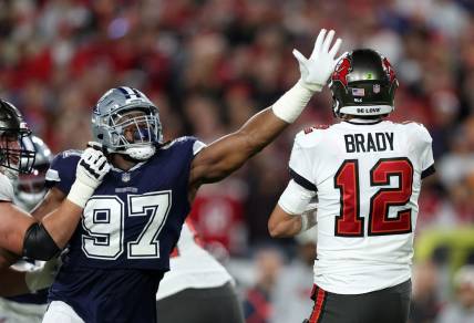 Jan 16, 2023; Tampa, Florida, USA; Dallas Cowboys defensive tackle Osa Odighizuwa (97) puts pressure on Tampa Bay Buccaneers quarterback Tom Brady (12) in the first half during the wild card game at Raymond James Stadium. Mandatory Credit: Nathan Ray Seebeck-USA TODAY Sports