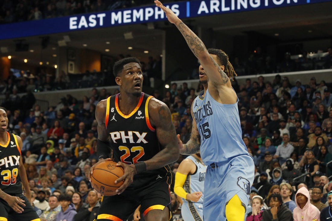 Jan 16, 2023; Memphis, Tennessee, USA; Phoenix Suns center Deandre Ayton (22) spins toward the basket as Memphis Grizzlies forward Brandon Clark (15) defends during the second half at FedExForum. Mandatory Credit: Petre Thomas-USA TODAY Sports