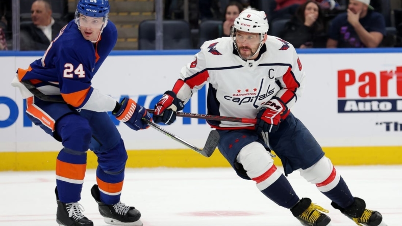 Jan 16, 2023; Elmont, New York, USA; Washington Capitals left wing Alex Ovechkin (8) skates against New York Islanders defenseman Scott Mayfield (24) during the third period at UBS Arena. Mandatory Credit: Brad Penner-USA TODAY Sports
