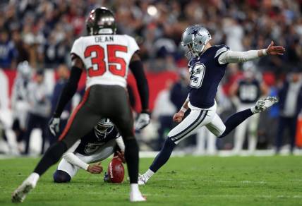 Jan 16, 2023; Tampa, Florida, USA; Dallas Cowboys place kicker Brett Maher (19) kicks a point after touchdown against the Tampa Bay Buccaneers in the second half during the wild card game at Raymond James Stadium. Mandatory Credit: Nathan Ray Seebeck-USA TODAY Sports
