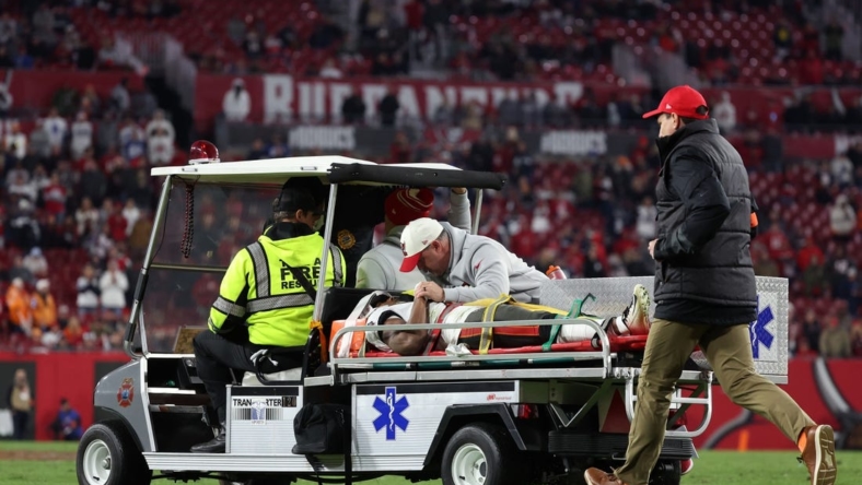 Jan 16, 2023; Tampa, Florida, USA; Tampa Bay Buccaneers wide receiver Russell Gage (17) is placed on a medical cart after a play against the Dallas Cowboys in the second half during the wild card game at Raymond James Stadium. Mandatory Credit: Kim Klement-USA TODAY Sports