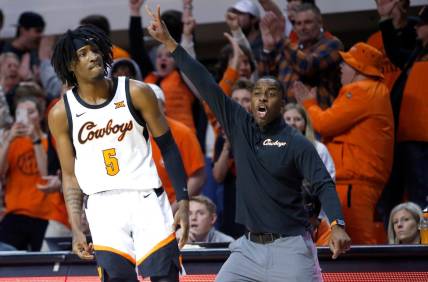 Oklahoma State head coach Mike Boynton and Caleb Asberry (5) react in the second half during the college basketball between the Oklahoma State Cowboys and the Texas Longhorns at Gallagher-Iba Arena in Stillwater, Okla., Saturday, Jan.7, 2023.

ss