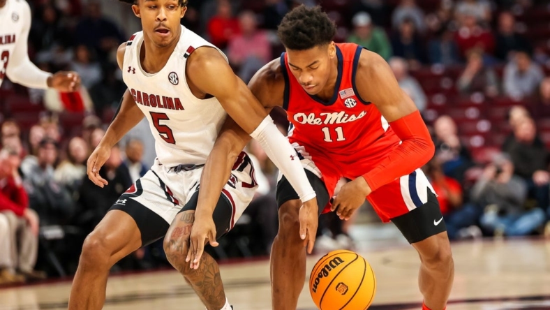 Jan 17, 2023; Columbia, South Carolina, USA; South Carolina Gamecocks guard Meechie Johnson (5) and Mississippi Rebels guard Matthew Murrell (11) battle for a loose ball in the first half at Colonial Life Arena. Mandatory Credit: Jeff Blake-USA TODAY Sports