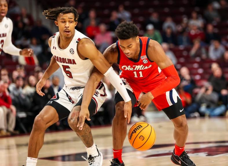 Jan 17, 2023; Columbia, South Carolina, USA; South Carolina Gamecocks guard Meechie Johnson (5) and Mississippi Rebels guard Matthew Murrell (11) battle for a loose ball in the first half at Colonial Life Arena. Mandatory Credit: Jeff Blake-USA TODAY Sports