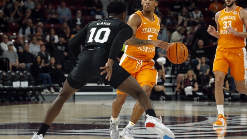 Jan 17, 2023; Starkville, Mississippi, USA; Tennessee Volunteers guard Zakai Zeigler (5) dribbles as Mississippi State Bulldogs guard Dashawn Davis (10) defends during the first half at Humphrey Coliseum. Mandatory Credit: Petre Thomas-USA TODAY Sports