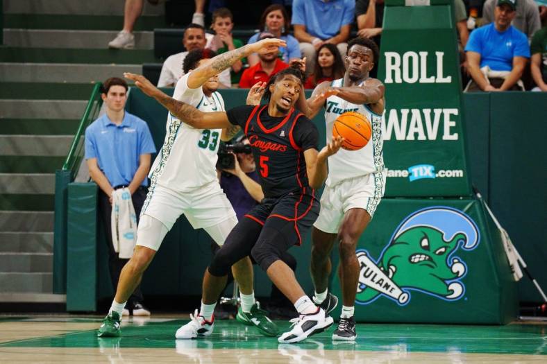 Jan 17, 2023; New Orleans, Louisiana, USA; Houston Cougars forward Ja'Vier Francis (5) fights for a rebound Tulane Green Wave forward Tylan Pope (33) during the second half at Avron B. Fogelman Arena in Devlin Fieldhouse. Mandatory Credit: Andrew Wevers-USA TODAY Sports