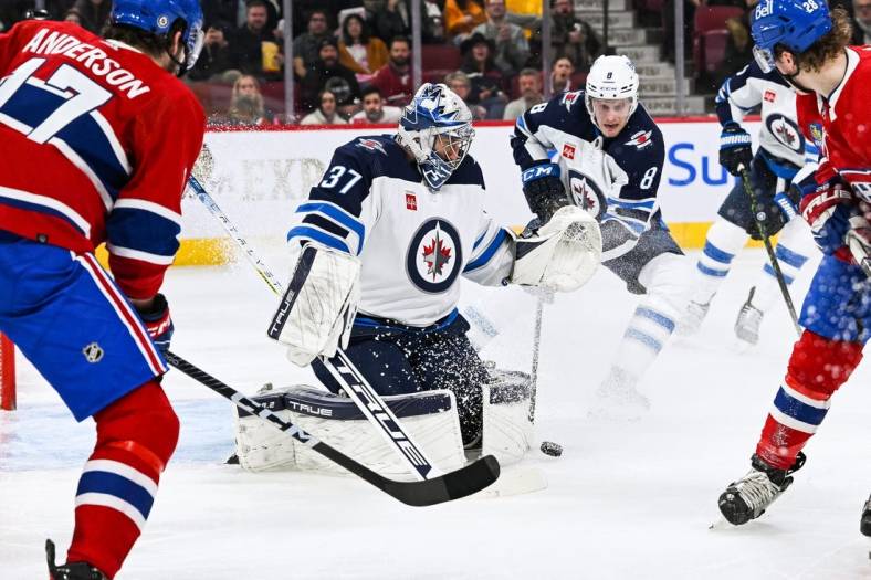 Jan 17, 2023; Montreal, Quebec, CAN; Winnipeg Jets goaltender Connor Hellebuyck (37) makes a save against the Montreal Canadiens during the second period at Bell Centre. Mandatory Credit: David Kirouac-USA TODAY Sports