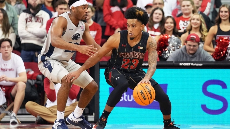Jan 17, 2023; Madison, Wisconsin, USA; Wisconsin Badgers guard Chucky Hepburn (23) dribbles the ball under coverage by Penn State Nittany Lions guard Jalen Pickett (22)  during the first half at the Kohl Center. Mandatory Credit: Kayla Wolf-USA TODAY Sports