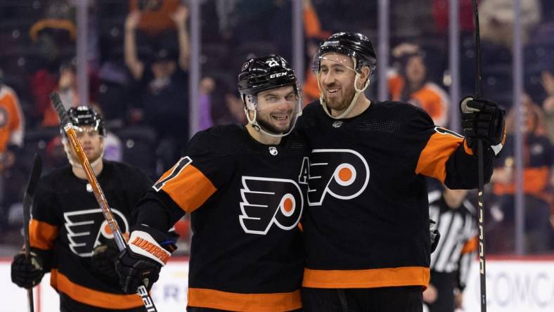 Jan 17, 2023; Philadelphia, Pennsylvania, USA; Philadelphia Flyers center Kevin Hayes (13) celebrates with center Scott Laughton (21) after scoring a goal for a hat trick against the Anaheim Ducks during the third period at Wells Fargo Center. Mandatory Credit: Bill Streicher-USA TODAY Sports