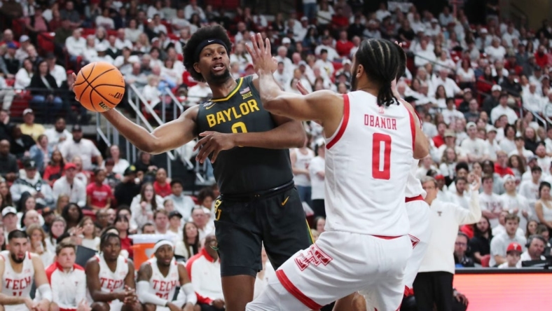 Jan 17, 2023; Lubbock, Texas, USA;  Baylor Bears forward Flo Thumb (0) passes the ball in front of the Texas Tech Red Raiders forward Kevin Obanor (0) in the first half at United Supermarkets Arena. Mandatory Credit: Michael C. Johnson-USA TODAY Sports