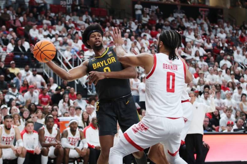 Jan 17, 2023; Lubbock, Texas, USA;  Baylor Bears forward Flo Thumb (0) passes the ball in front of the Texas Tech Red Raiders forward Kevin Obanor (0) in the first half at United Supermarkets Arena. Mandatory Credit: Michael C. Johnson-USA TODAY Sports