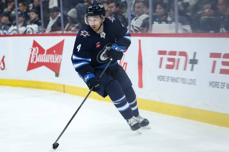 Jan 15, 2023; Winnipeg, Manitoba, CAN;  Winnipeg Jets defenseman Neal Pionk (4) against the Arizona Coyotes during the first period at Canada Life Centre. Mandatory Credit: Terrence Lee-USA TODAY Sports