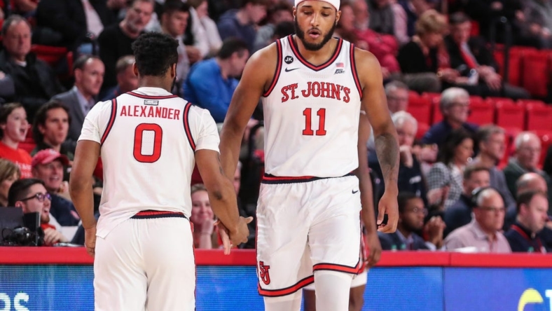 Jan 10, 2023; Queens, New York, USA;  St. John's Red Storm guard Posh Alexander (0) and center Joel Soriano (11) at Carnesecca Arena. Mandatory Credit: Wendell Cruz-USA TODAY Sports