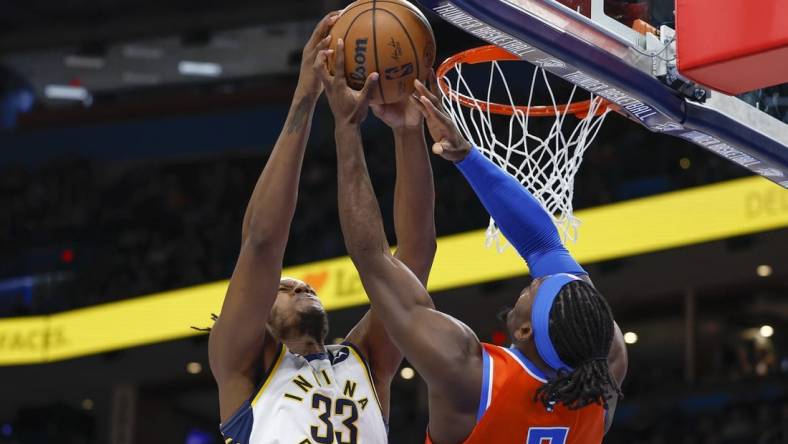 Jan 18, 2023; Oklahoma City, Oklahoma, USA; Indiana Pacers center Myles Turner (33) and Oklahoma City Thunder guard Luguentz Dort (5) fight for a rebound during the second quarter at Paycom Center. Mandatory Credit: Alonzo Adams-USA TODAY Sports