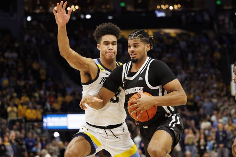 Jan 18, 2023; Milwaukee, Wisconsin, USA;  Providence Friars forward Bryce Hopkins (23) drives for the basket against Marquette Golden Eagles forward Oso Ighodaro (13) during the first half at Fiserv Forum. Mandatory Credit: Jeff Hanisch-USA TODAY Sports