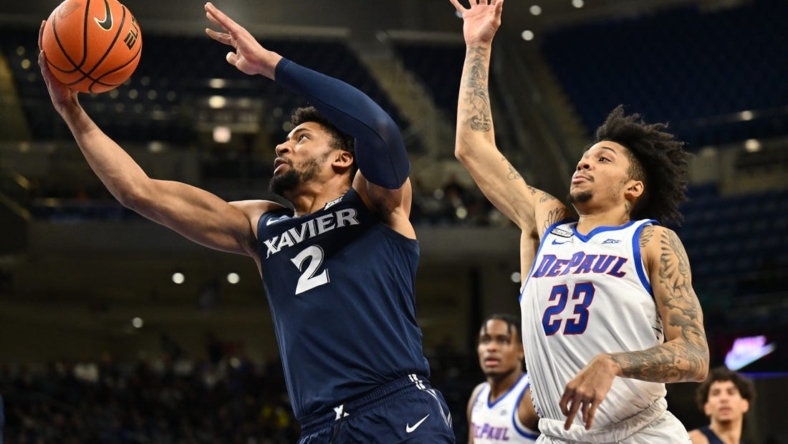 Jan 18, 2023; Chicago, Illinois, USA; Xavier Musketeers forward Jerome Hunter (2) sails past DePaul Blue Demons guard Caleb Murphy (23) for a lay up in the first half at Wintrust Arena. Mandatory Credit: Jamie Sabau-USA TODAY Sports