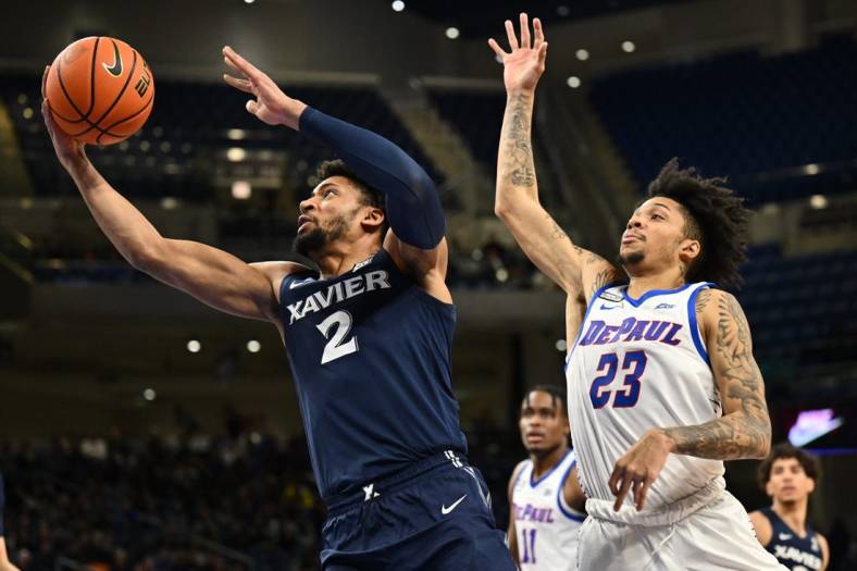 Jan 18, 2023; Chicago, Illinois, USA; Xavier Musketeers forward Jerome Hunter (2) sails past DePaul Blue Demons guard Caleb Murphy (23) for a lay up in the first half at Wintrust Arena. Mandatory Credit: Jamie Sabau-USA TODAY Sports