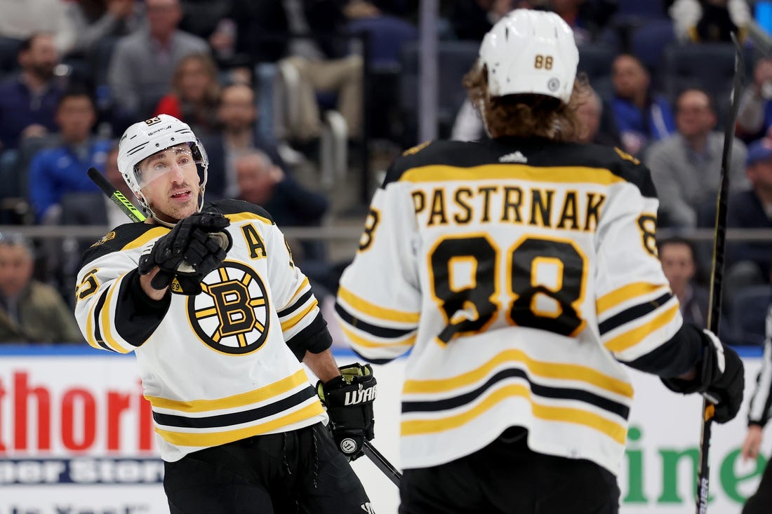 Jan 18, 2023; Elmont, New York, USA; Boston Bruins left wing Brad Marchand (63) celebrates his goal against the New York Islanders with right wing David Pastrnak (88) during the third period at UBS Arena. Mandatory Credit: Brad Penner-USA TODAY Sports
