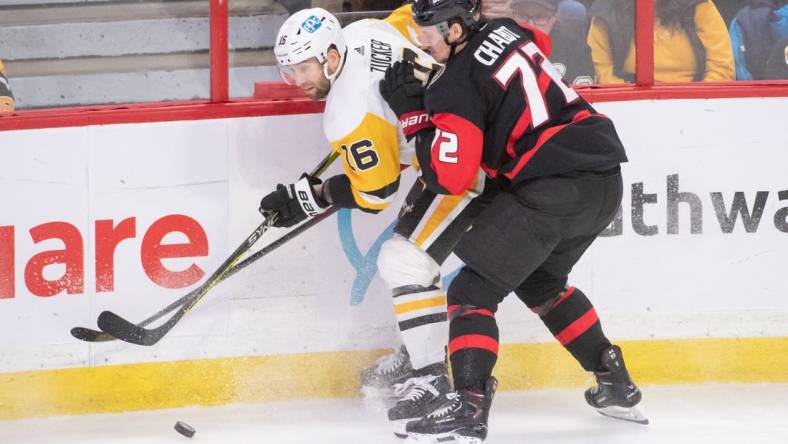 Jan 18, 2023; Ottawa, Ontario, CAN; Pittsburgh Penguins left wing Jason Zucker (16) and Ottawa Senators defenseman Thomas Chabot (72) battle for the puck in the third period at the Canadian Tire Centre. Mandatory Credit: Marc DesRosiers-USA TODAY Sports