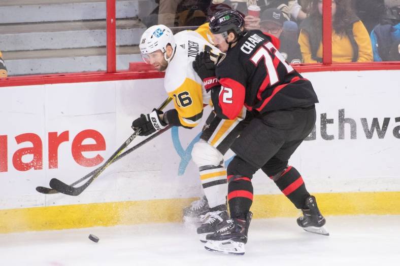 Jan 18, 2023; Ottawa, Ontario, CAN; Pittsburgh Penguins left wing Jason Zucker (16) and Ottawa Senators defenseman Thomas Chabot (72) battle for the puck in the third period at the Canadian Tire Centre. Mandatory Credit: Marc DesRosiers-USA TODAY Sports