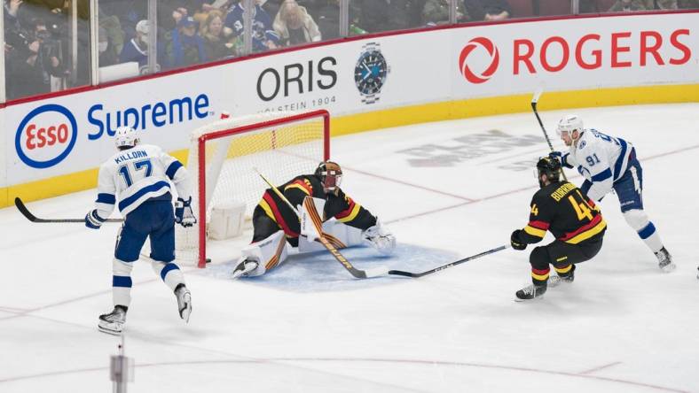 Jan 18, 2023; Vancouver, British Columbia, CAN; Tampa Bay Lightning forward Alex Killorn (17) watches as forward Steven Stamkos (91) scores his 500th career NHL goal on Vancouver Canucks goalie Spencer Martin (30) while defenseman Kyle Burroughs (44) looks on in the first period at Rogers Arena. Mandatory Credit: Bob Frid-USA TODAY Sports