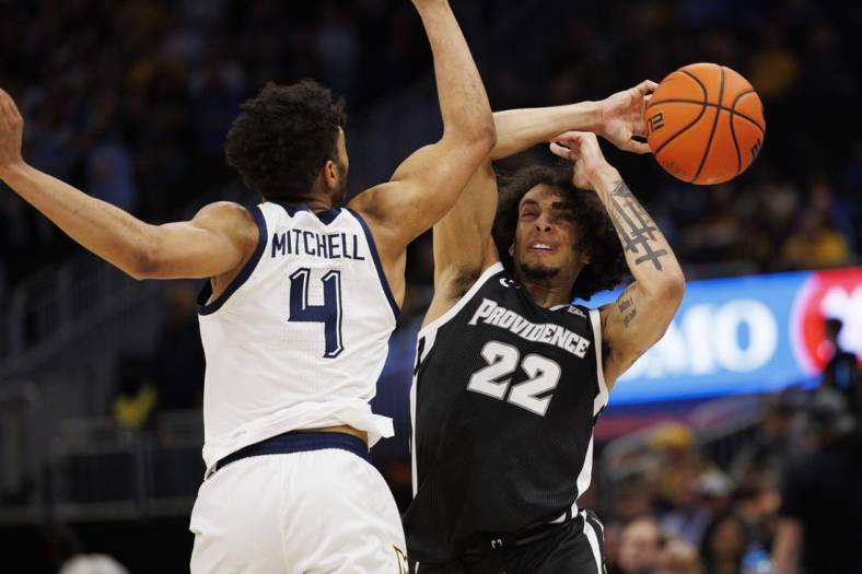 Jan 18, 2023; Milwaukee, Wisconsin, USA;  Providence Friars guard Devin Carter (22) loses the ball under pressure from Marquette Golden Eagles guard Stevie Mitchell (4) during the first half at Fiserv Forum. Mandatory Credit: Jeff Hanisch-USA TODAY Sports