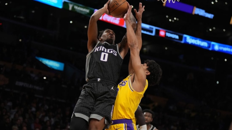 Jan 18, 2023; Los Angeles, California, USA; Sacramento Kings guard Malik Monk (0) shoots the ball against Los Angeles Lakers guard Max Christie (10) in the first half at Crypto.com Arena. Mandatory Credit: Kirby Lee-USA TODAY Sports