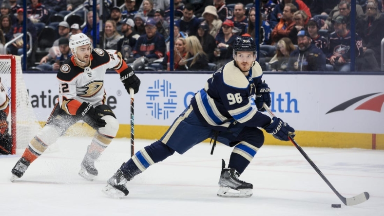 Jan 19, 2023; Columbus, Ohio, USA;  Columbus Blue Jackets center Jack Roslovic (96) skates with the puck against Anaheim Ducks defenseman Kevin Shattenkirk (22) in the first period at Nationwide Arena. Mandatory Credit: Aaron Doster-USA TODAY Sports