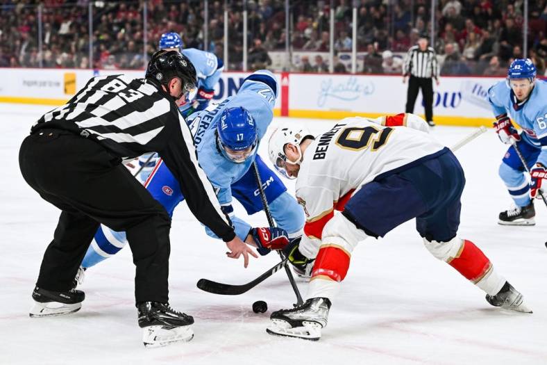 Jan 19, 2023; Montreal, Quebec, CAN; NHL linesman Matt MacPherson (83) drops the puck at a face-off between Montreal Canadiens right wing Josh Anderson (17) and Florida Panthers center Sam Bennett (9) during the first period at Bell Centre. Mandatory Credit: David Kirouac-USA TODAY Sports