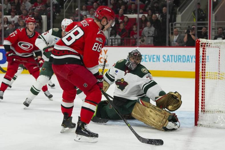 Jan 19, 2023; Raleigh, North Carolina, USA; Minnesota Wild goaltender Marc-Andre Fleury (29) makes a save against Carolina Hurricanes center Martin Necas (88) during the first period at PNC Arena. Mandatory Credit: James Guillory-USA TODAY Sports